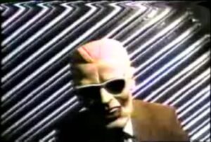Max Headroom, FOTO: Unknown, see en:Max Headroom broadcast signal intrusion incident., Public domain, via Wikimedia Commons