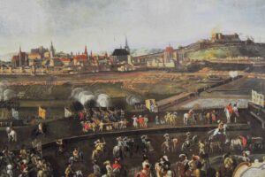 Historical cityscape along a river; foreground shows soldiers, cannons, and horses in a military scene.