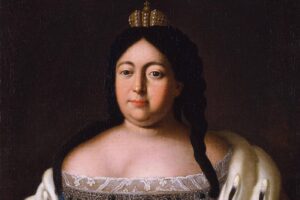 Formal oil portrait of a woman with long dark hair, wearing a small crown and a silver-embroidered dress against a dark background.