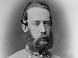 Head-and-shoulders portrait of a bearded man in a vintage military uniform, looking slightly to the right.
